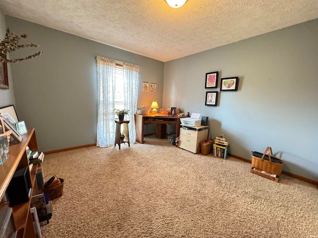 office area with a textured ceiling and carpet