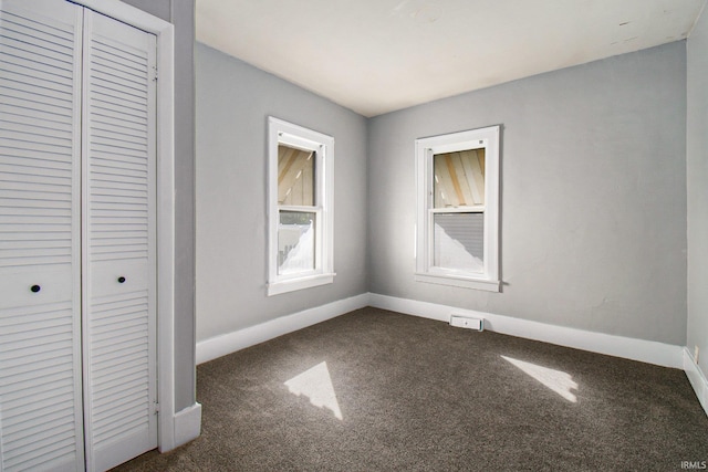 unfurnished bedroom featuring a closet and carpet flooring