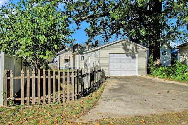 view of side of home with a garage and an outdoor structure