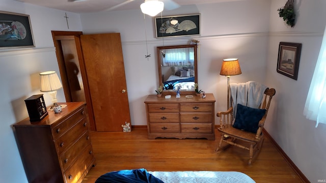 sitting room featuring wood-type flooring and ceiling fan