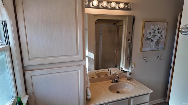 bathroom with a shower with door and vanity