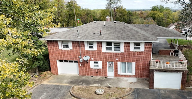 view of front of property featuring a balcony and a garage