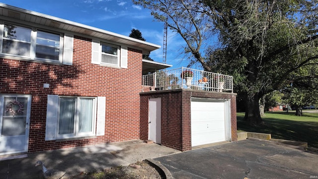 view of side of property with a garage and a balcony