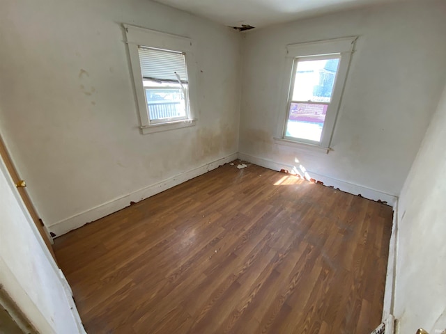 spare room with dark hardwood / wood-style flooring