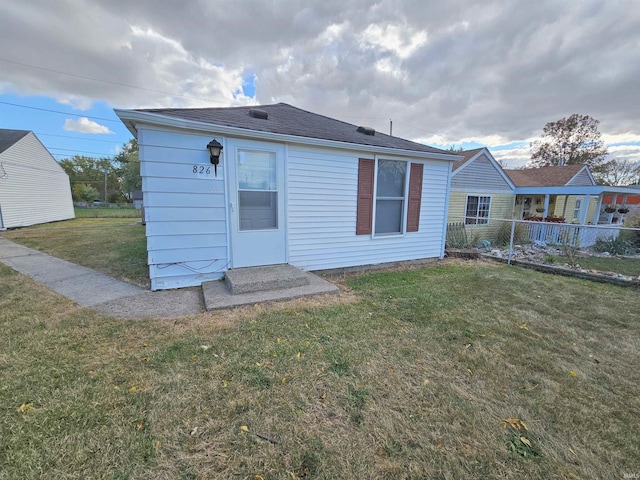 back of house with a lawn