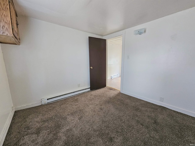 unfurnished room featuring dark colored carpet and a baseboard radiator