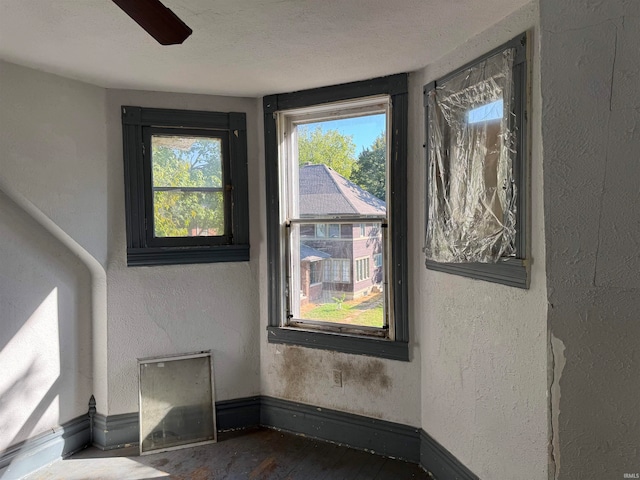 interior space with ceiling fan and a textured ceiling