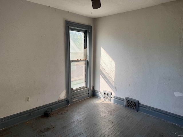 empty room with wood-type flooring and ceiling fan