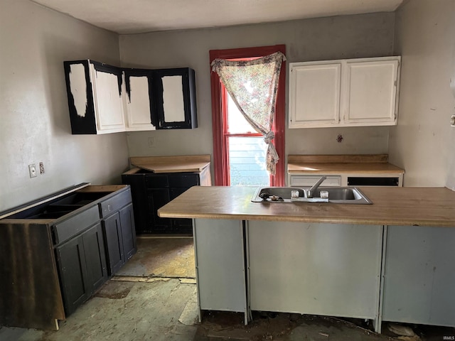 kitchen featuring sink and white cabinets