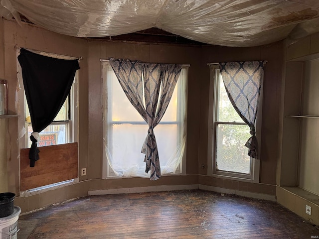 empty room with lofted ceiling and hardwood / wood-style floors