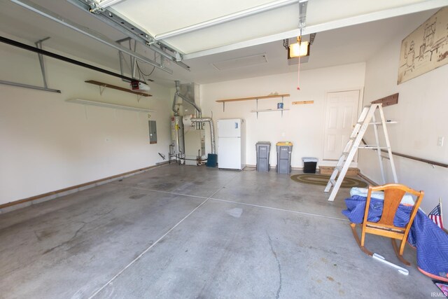 garage with electric panel, a garage door opener, and white fridge