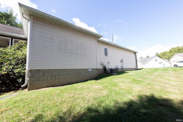 view of side of home featuring central air condition unit and a lawn