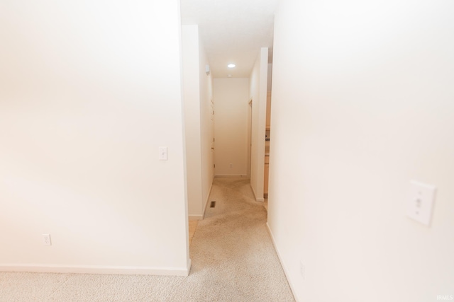 hallway featuring light carpet