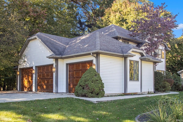 view of property exterior with a lawn and a garage