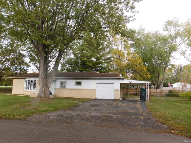 view of front facade with a front lawn, a carport, and a garage