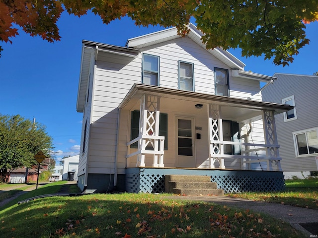 view of front facade with a front lawn and a porch