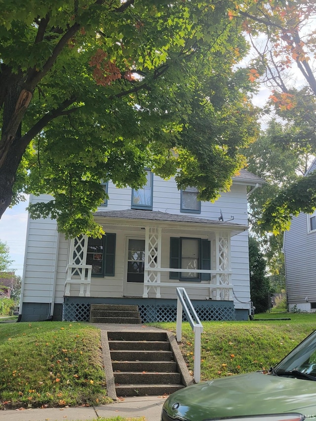 view of front of house with a front lawn and a porch