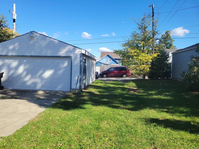 exterior space featuring a garage and a lawn