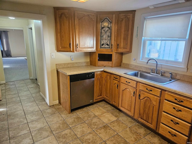 kitchen with light tile patterned floors, dishwasher, and sink