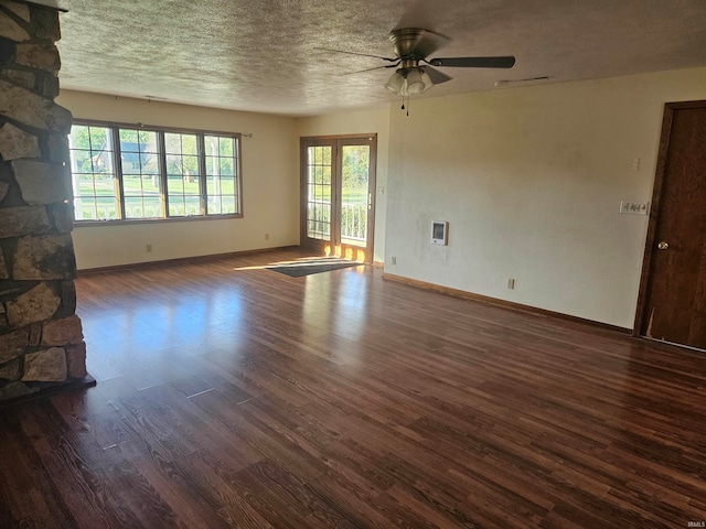 unfurnished living room with ceiling fan, a textured ceiling, and dark hardwood / wood-style flooring