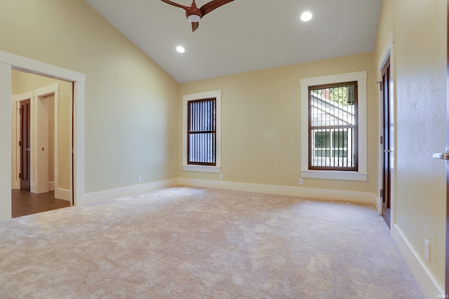 carpeted empty room with ceiling fan and vaulted ceiling