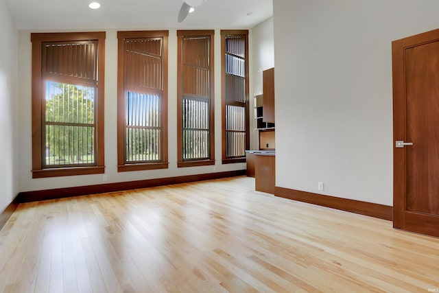 empty room featuring ceiling fan and light hardwood / wood-style flooring