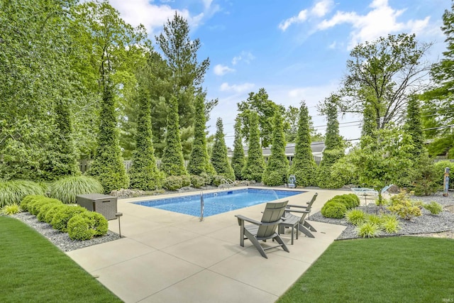 view of swimming pool featuring a patio and a lawn