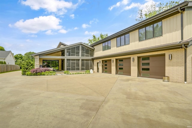 view of front facade featuring a garage and a sunroom