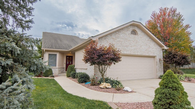 view of front of property with a front yard and a garage