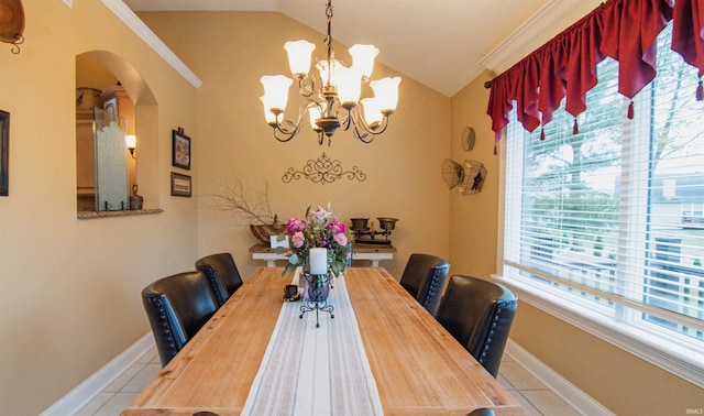 dining space with vaulted ceiling, a notable chandelier, and light tile patterned flooring