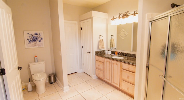 bathroom with vanity, walk in shower, toilet, and tile patterned floors