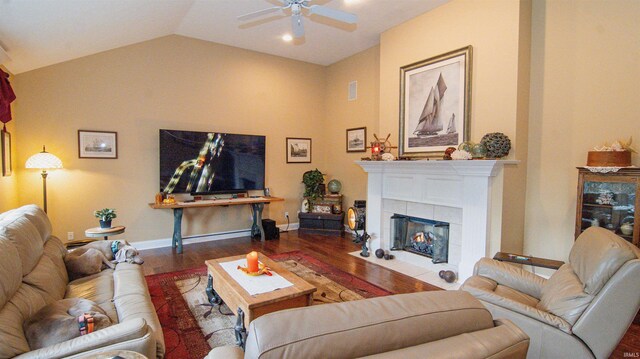 living room with lofted ceiling, hardwood / wood-style floors, a fireplace, and ceiling fan