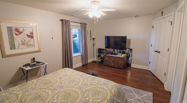 bedroom with dark hardwood / wood-style floors, a closet, and ceiling fan