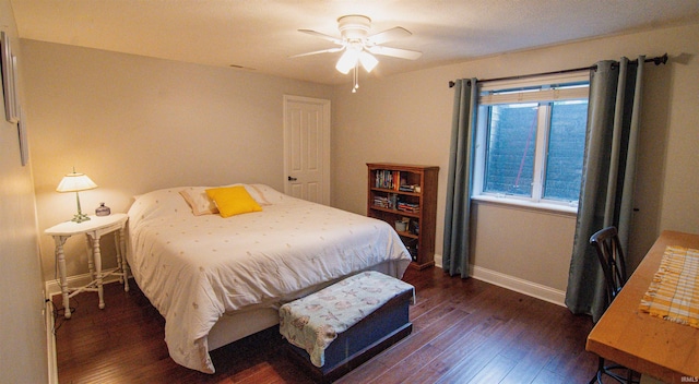 bedroom featuring ceiling fan and dark hardwood / wood-style floors