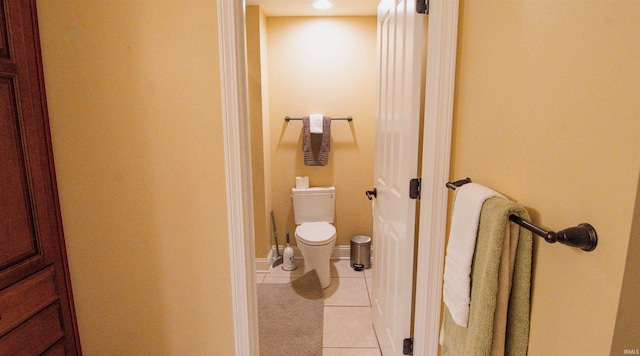 bathroom featuring toilet and tile patterned flooring