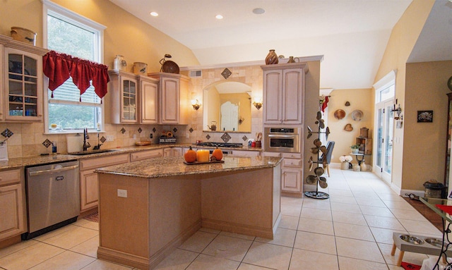 kitchen featuring a center island, stainless steel appliances, vaulted ceiling, and backsplash