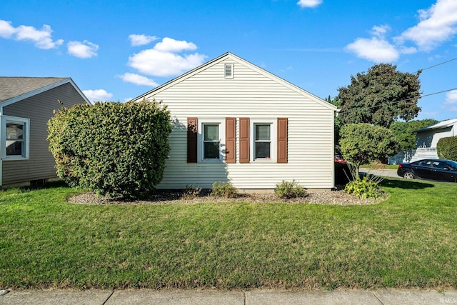 view of side of property with a yard