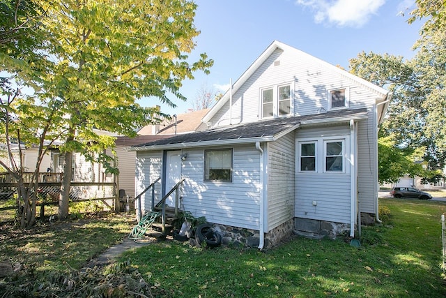 rear view of house with a lawn