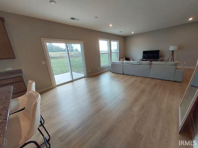 unfurnished living room featuring light wood-type flooring