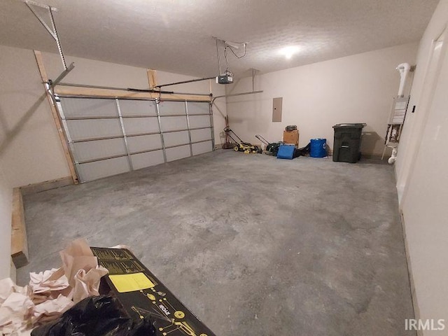 garage featuring water heater, a garage door opener, and electric panel