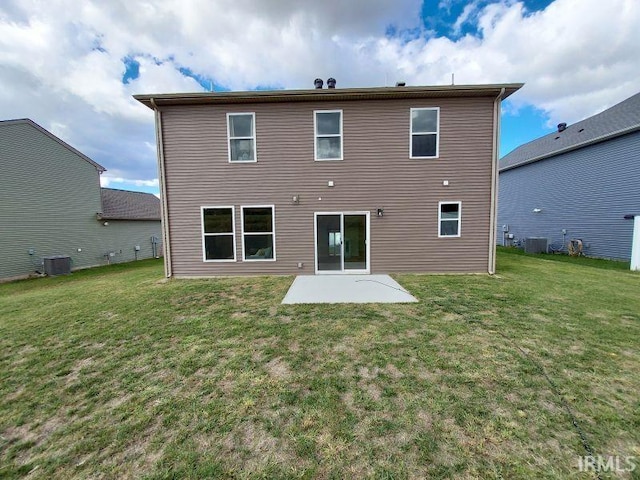 rear view of house with central AC, a lawn, and a patio area