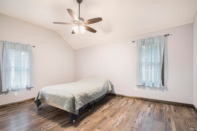 bedroom featuring multiple windows, wood-type flooring, lofted ceiling, and ceiling fan