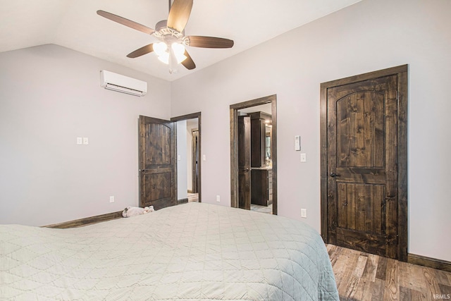 bedroom featuring ceiling fan, vaulted ceiling, a wall unit AC, and hardwood / wood-style floors