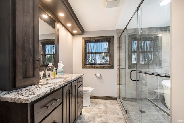 bathroom with vanity, toilet, and walk in shower