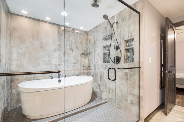 bathroom featuring tile walls, separate shower and tub, and tile patterned floors