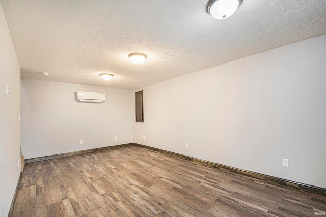 basement with a textured ceiling and wood-type flooring