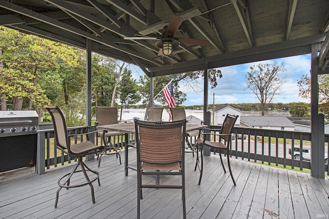 deck featuring area for grilling and ceiling fan