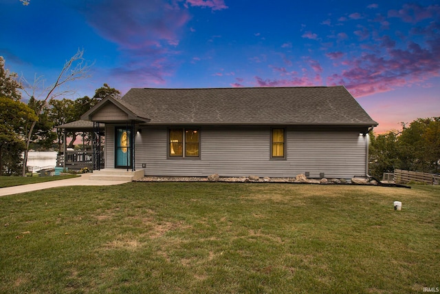 view of front of home featuring covered porch and a yard