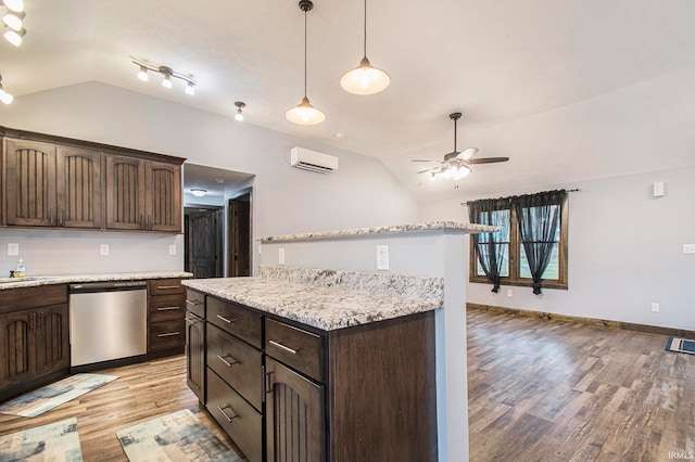 kitchen featuring light hardwood / wood-style flooring, lofted ceiling, and stainless steel dishwasher