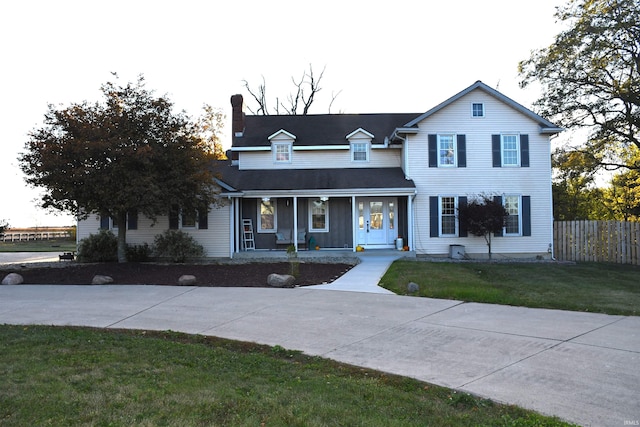 view of front of home featuring a front yard and a porch